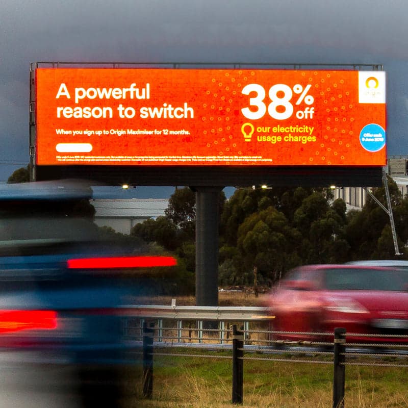 Free-standing LED billboard beside a road, showing a 38% off ad.