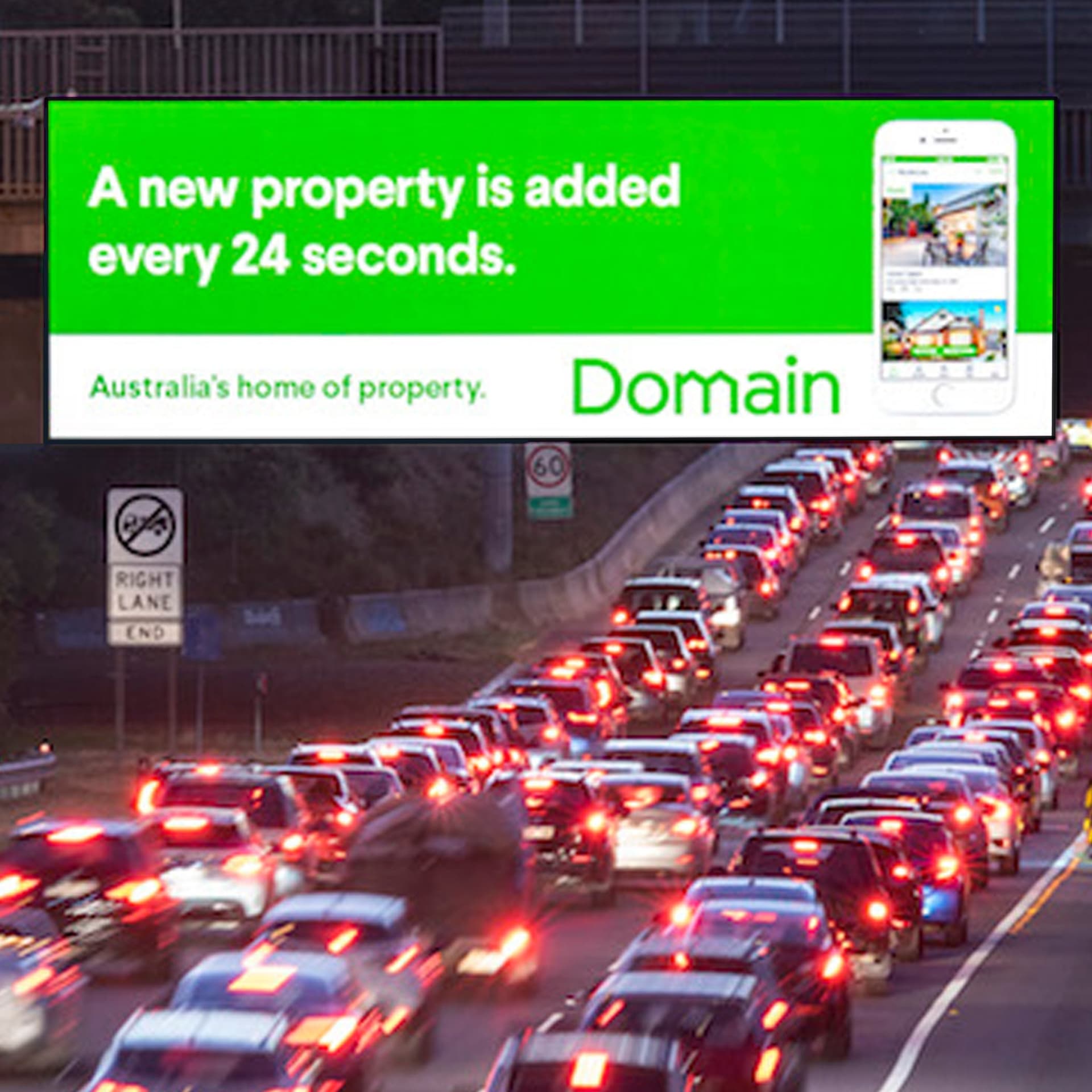 LED billboard beside a busy road at dusk, showing a Domain property ad.