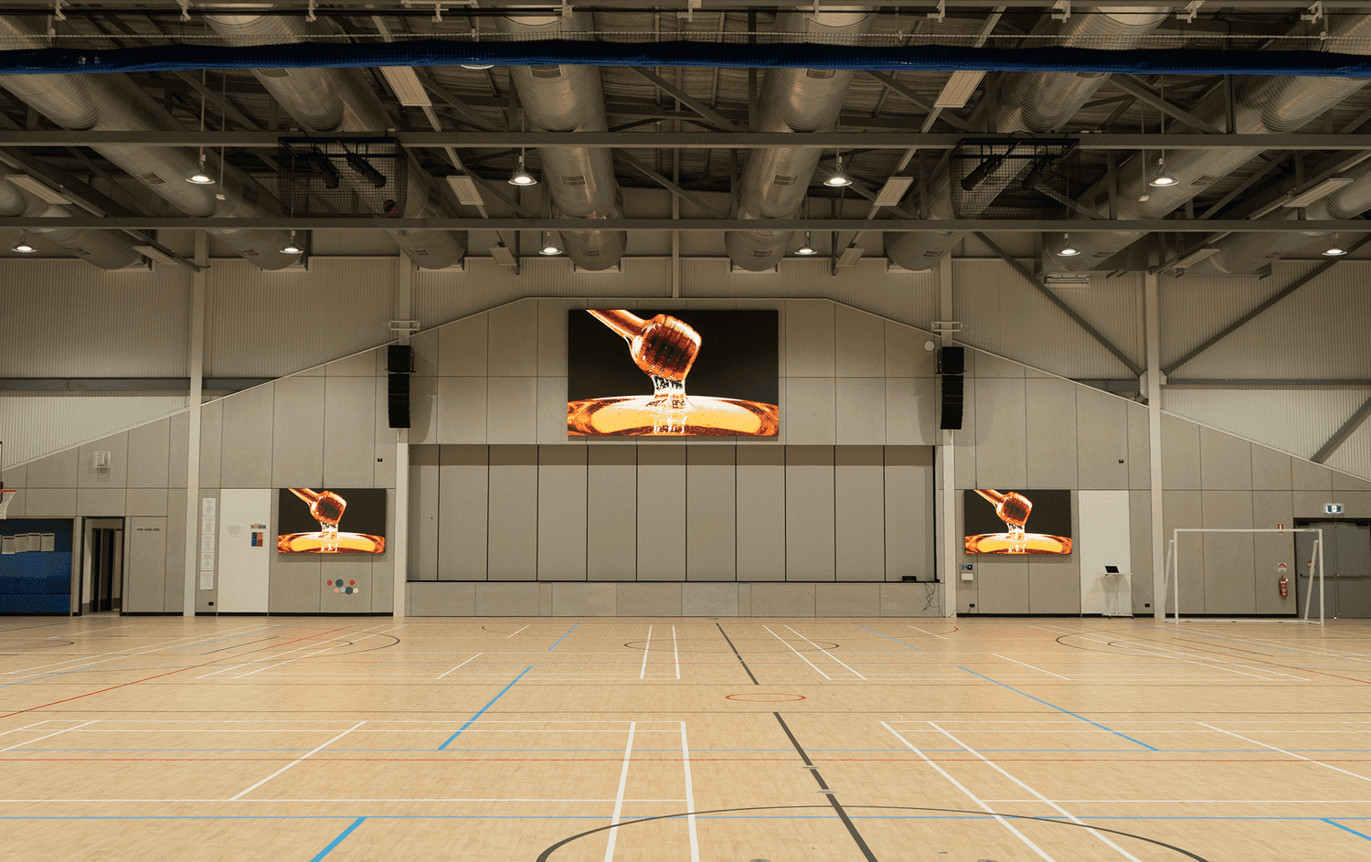 Sportal LED scoreboard above an indoor court.