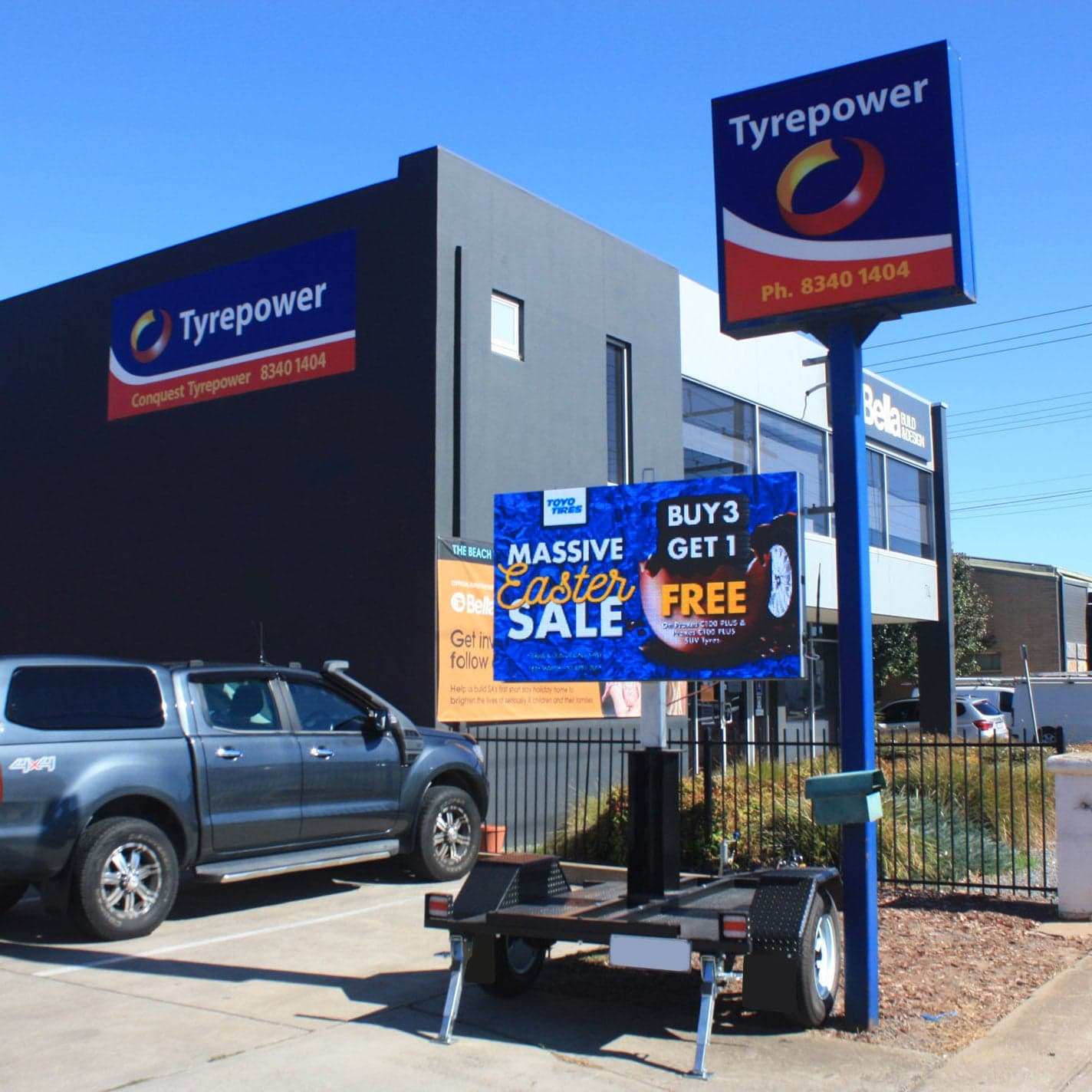 Small LED trailer outside a tyre shop, showing an Easter tyre sale.